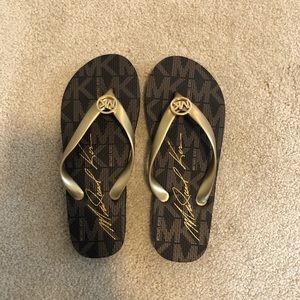 Brand new MK flip flops! NEVER WARN